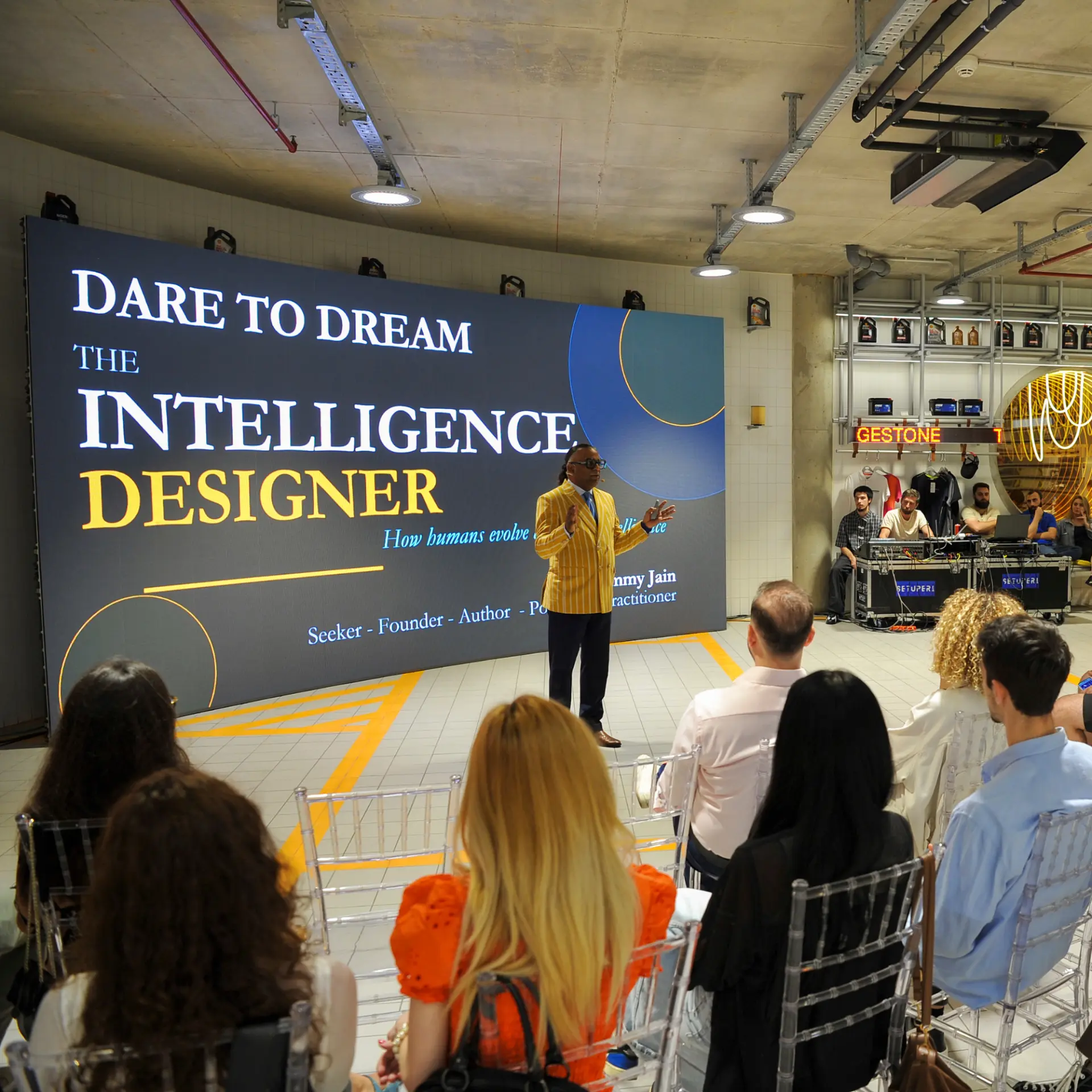 Keynote speaker on stage at Dare to Lead in front of a large screen and seated audience