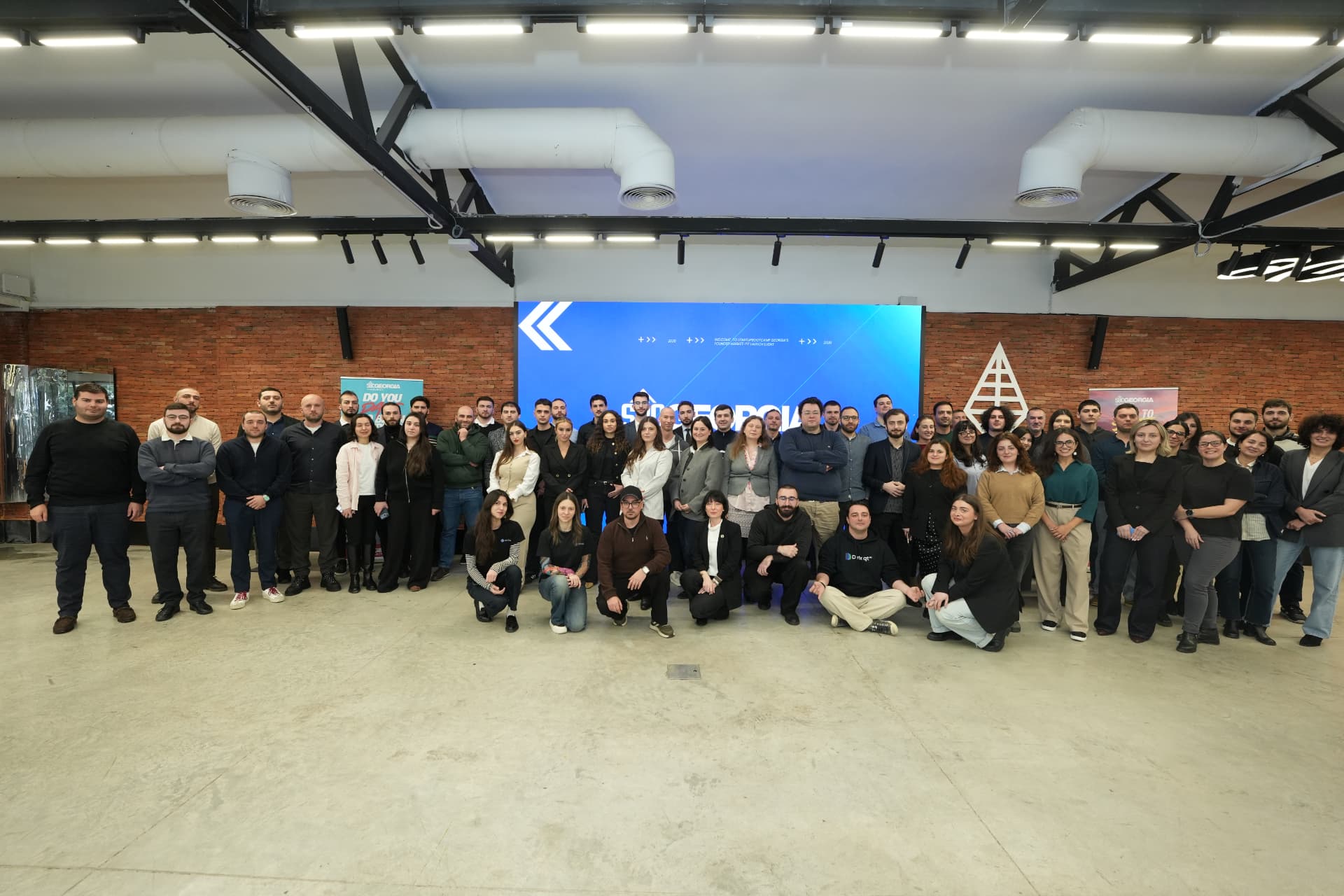 The 2026 Dare to Start cohort gathered in a brick-walled event hall in front of an SBC Georgia screen
